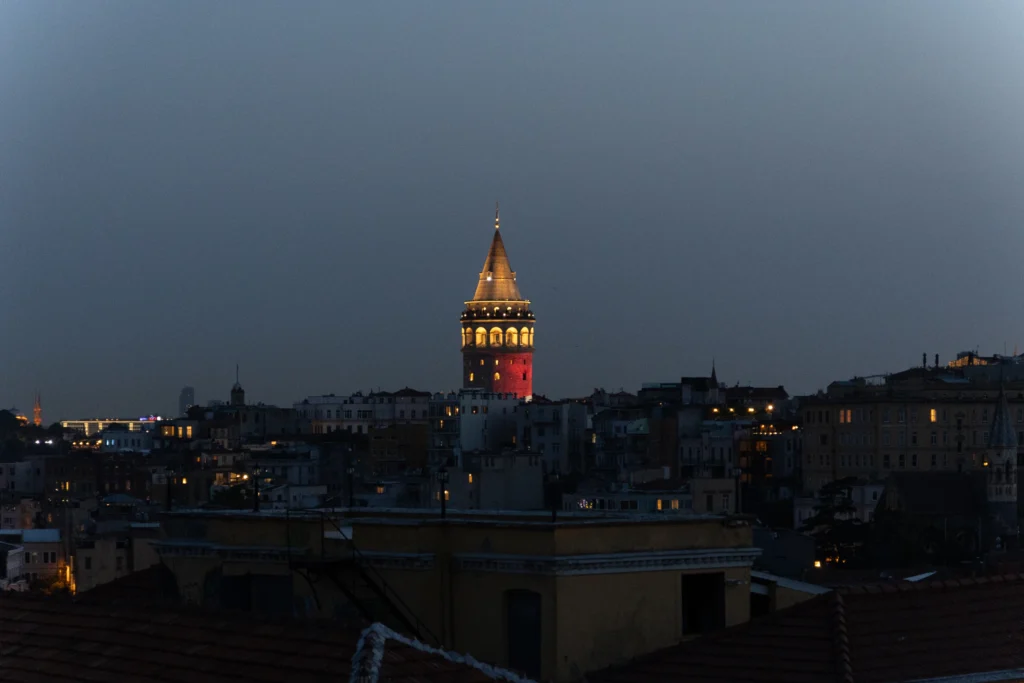Galata Tower illuminated in the Istanbul skyline from Arwin Roof