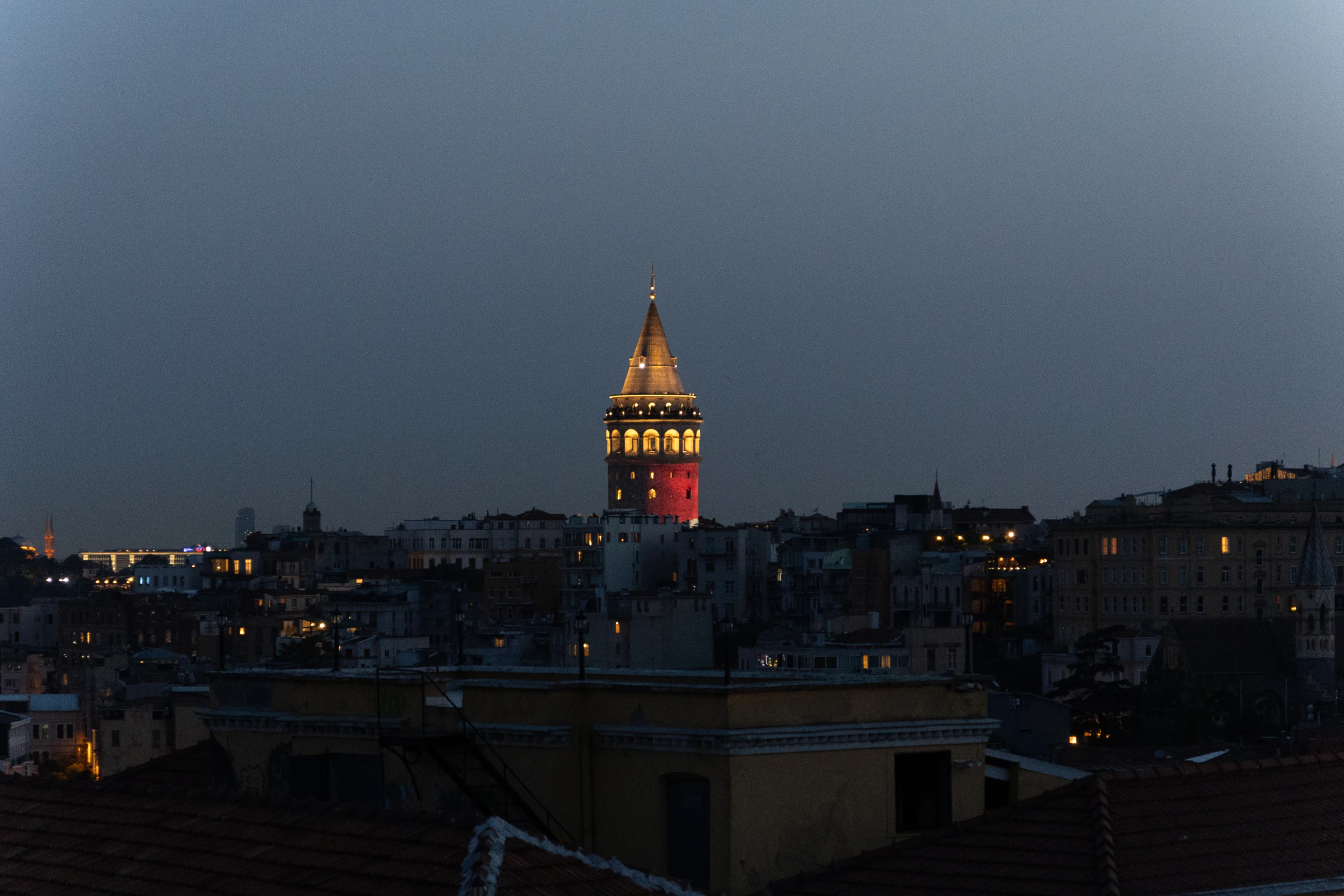 Galata Tower illuminated in the Istanbul skyline from Arwin Roof