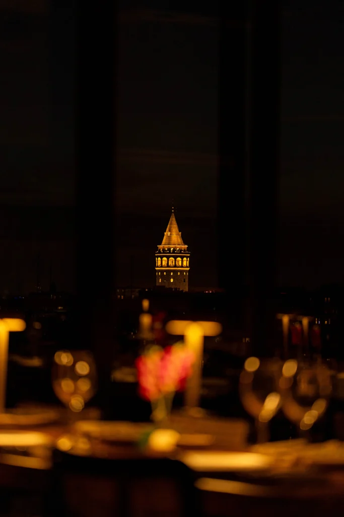Galata Tower and Istanbul city lights seen from Arwin Roof at night