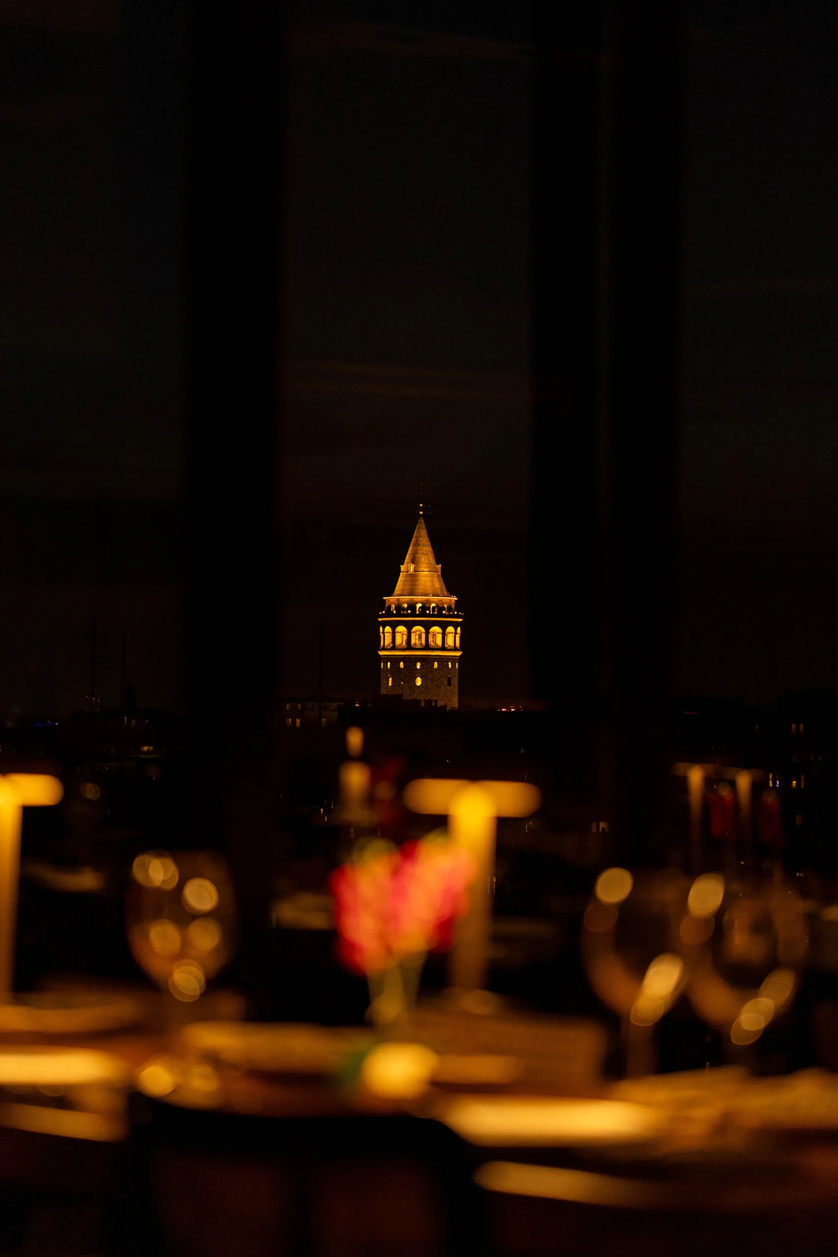 Galata Tower and Istanbul city lights seen from Arwin Roof at night